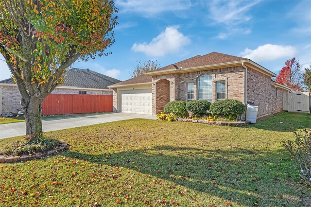 ranch-style home with a garage and a front lawn