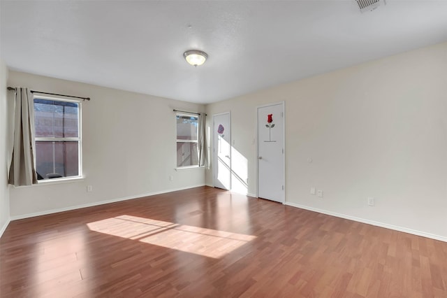 empty room with hardwood / wood-style flooring