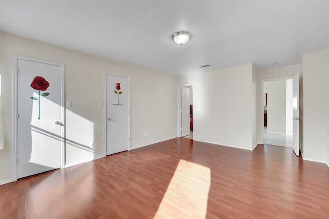 spare room with hardwood / wood-style flooring