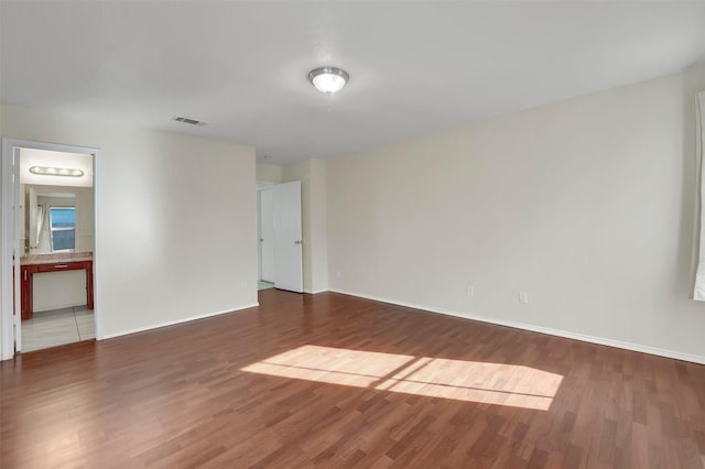 empty room with hardwood / wood-style floors