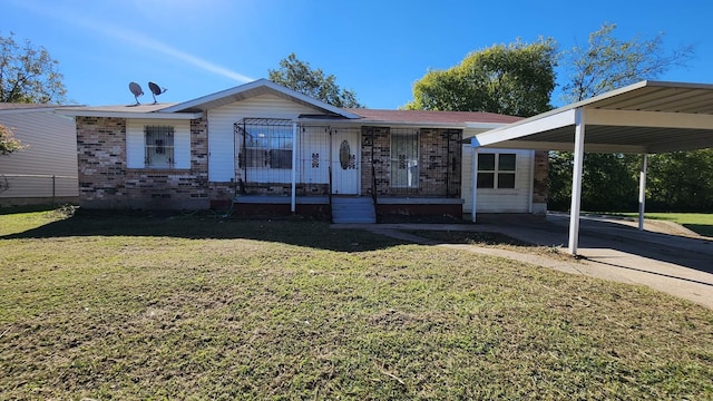 single story home with a front yard and a carport