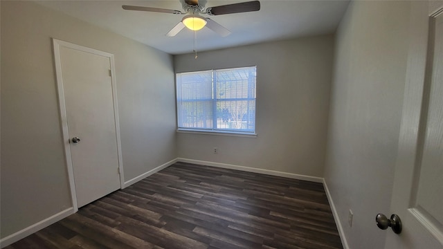 empty room with dark hardwood / wood-style floors and ceiling fan