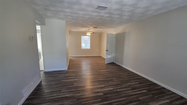 spare room with ceiling fan and dark wood-type flooring