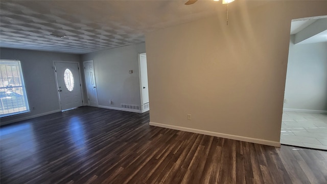 foyer with dark hardwood / wood-style floors and ceiling fan