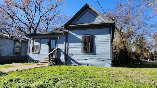 bungalow-style home with a front yard