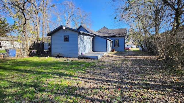 back of property featuring a yard