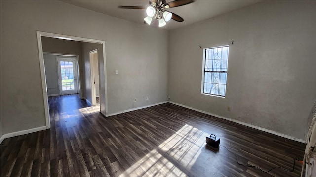 empty room with ceiling fan and dark hardwood / wood-style flooring