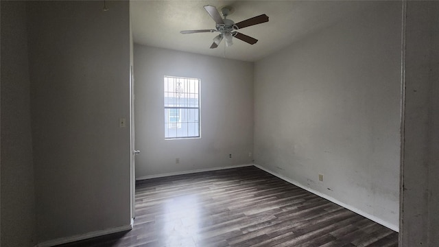 unfurnished room featuring dark wood-type flooring and ceiling fan