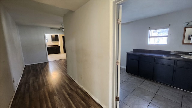 corridor featuring hardwood / wood-style flooring and sink