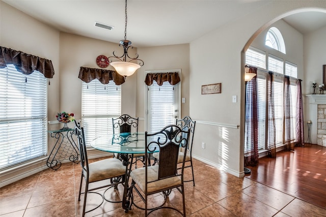 dining space with dark tile patterned floors and a healthy amount of sunlight