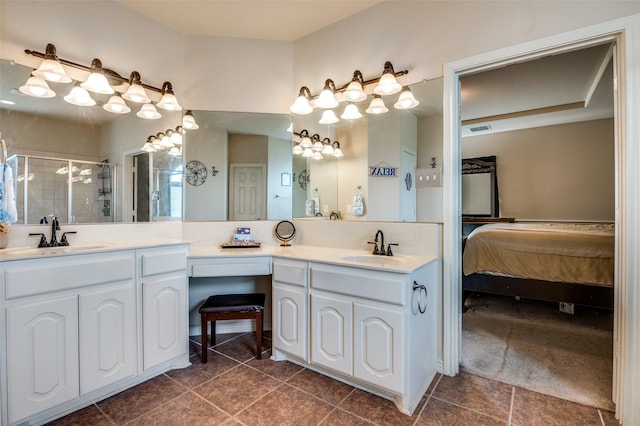 bathroom with a shower with shower door and vanity