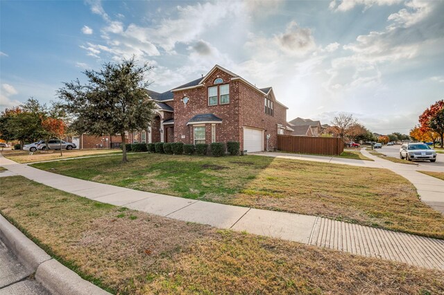 view of front of property with a garage and a front lawn