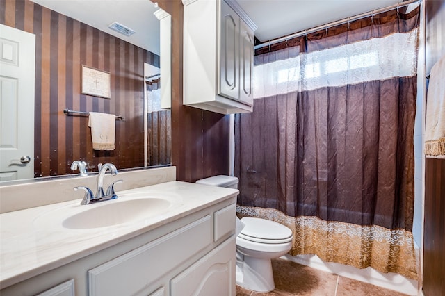 bathroom with walk in shower, toilet, tile patterned floors, and vanity