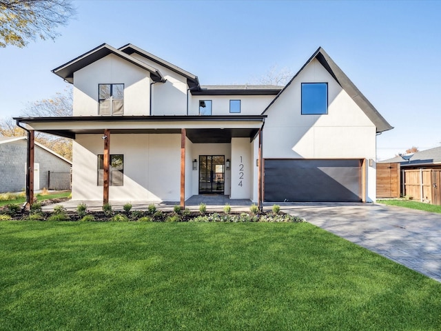 modern farmhouse with a garage, covered porch, and a front lawn