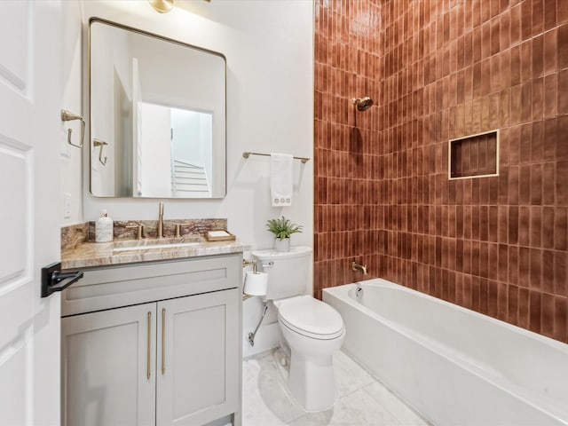 full bathroom featuring vanity, tile patterned flooring, tiled shower / bath combo, and toilet