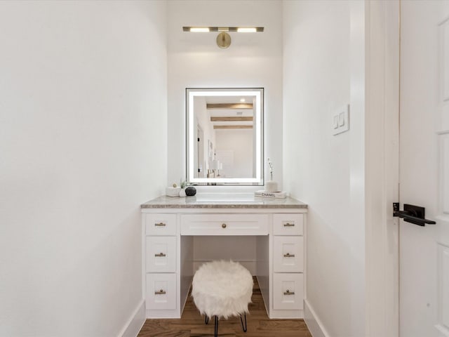 bathroom featuring beam ceiling, vanity, and wood-type flooring