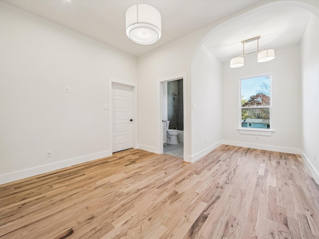 empty room with light hardwood / wood-style flooring