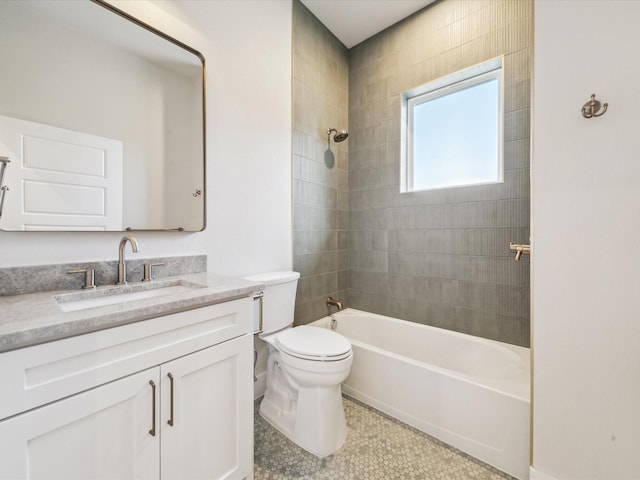 full bathroom featuring toilet, tiled shower / bath combo, tile patterned floors, and vanity