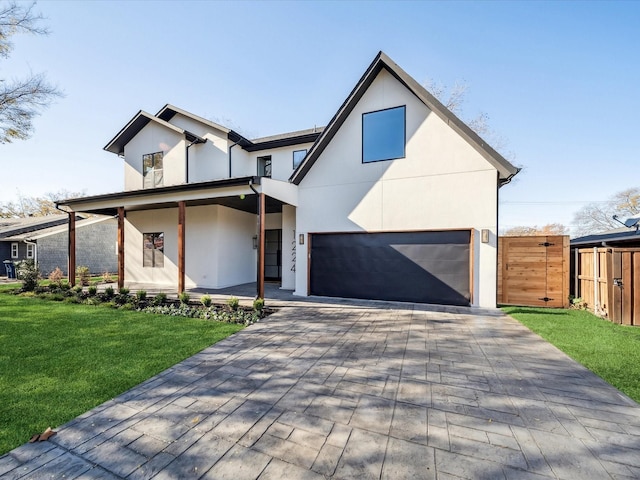 view of front of home featuring a front yard and a garage