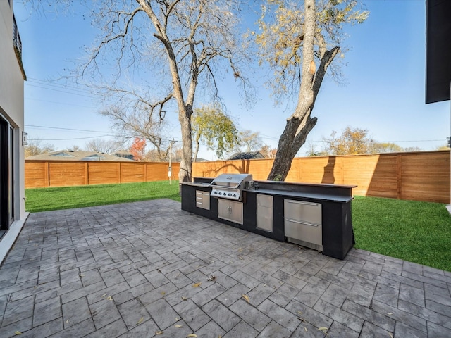 view of patio featuring area for grilling and a grill