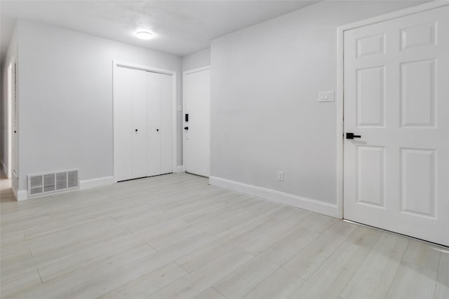 spare room featuring light wood-type flooring