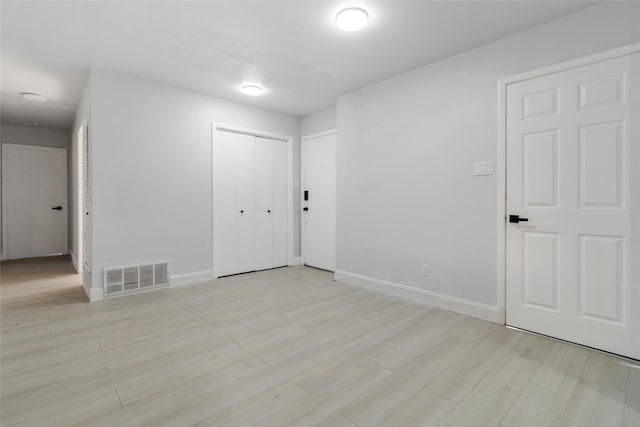 spare room with light hardwood / wood-style flooring