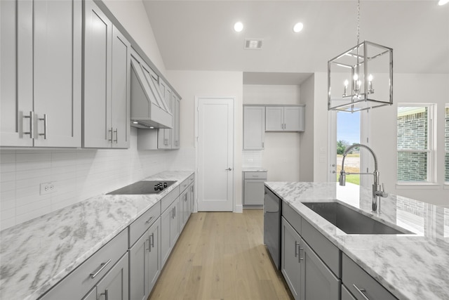 313 Slimp Blf, Azle, TX 76020 - kitchen featuring gray cabinetry, black electric stovetop, light stone countertops, decorative backsplash, and a chandelier