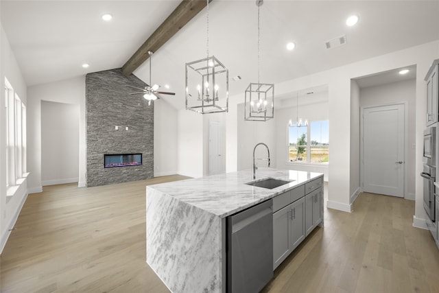 313 Slimp Blf, Azle, TX 76020 - kitchen featuring stainless steel dishwasher, a chandelier, a ceiling fan, gray cabinets, and a fireplace