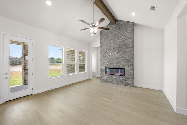 313 Slimp Blf, Azle, TX 76020 - unfurnished living room featuring beamed ceiling, light wood-type flooring, ceiling fan, a stone fireplace, and high vaulted ceiling