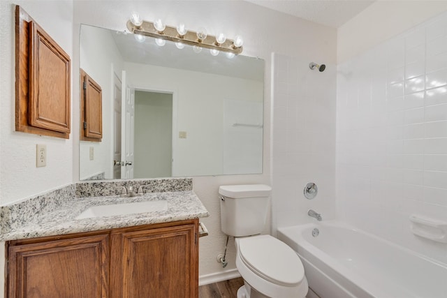 full bathroom featuring vanity, a textured ceiling, tiled shower / bath combo, wood-type flooring, and toilet