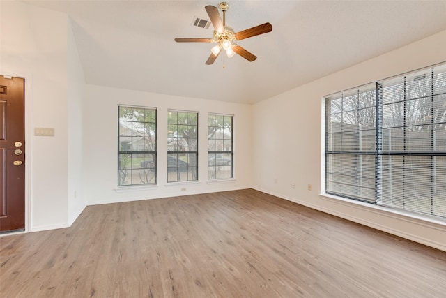 spare room with light wood-type flooring and ceiling fan