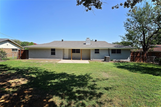 back of house with central AC unit, a yard, and a patio