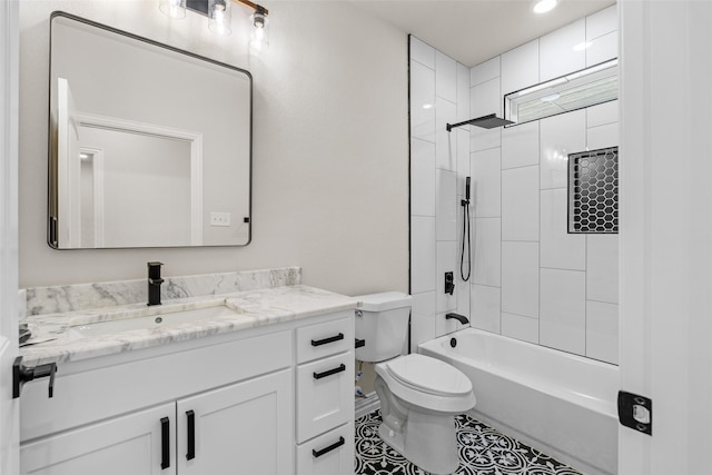 full bathroom featuring tile patterned flooring, vanity, toilet, and tiled shower / bath combo