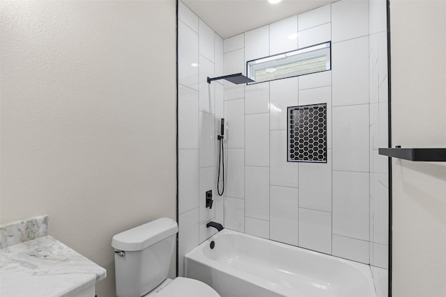 full bathroom featuring toilet, vanity, and tiled shower / bath