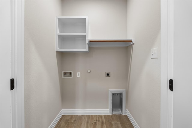 washroom featuring hookup for an electric dryer, gas dryer hookup, hardwood / wood-style floors, and washer hookup