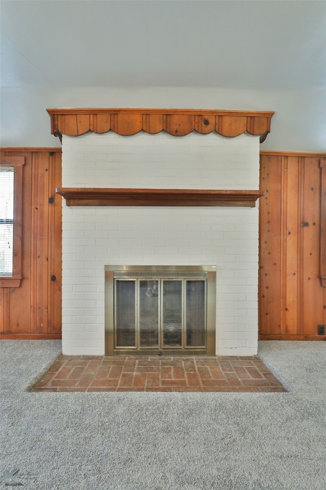 details featuring carpet flooring, a fireplace, and wood walls