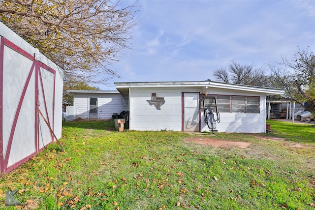 view of outbuilding featuring a yard