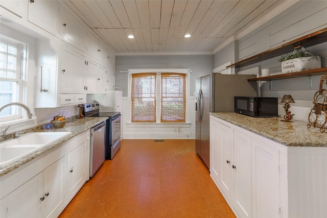 kitchen with sink, light stone countertops, appliances with stainless steel finishes, white cabinetry, and wood ceiling