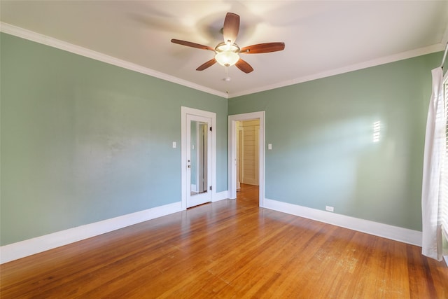 spare room with hardwood / wood-style flooring, ceiling fan, and crown molding