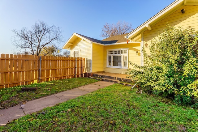 view of home's exterior with a lawn