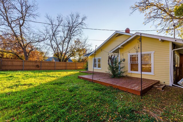 back of house with a lawn and a wooden deck