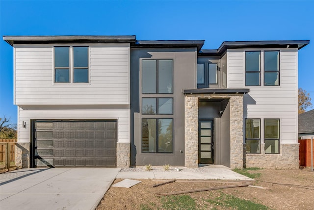 3919 Furey St, Dallas, TX 75212 - contemporary house with stone siding, fence, driveway, and an attached garage