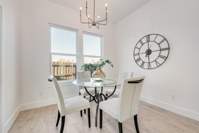 3919 Furey St, Dallas, TX 75212 - dining space with a chandelier, light wood-style floors, baseboards, and vaulted ceiling