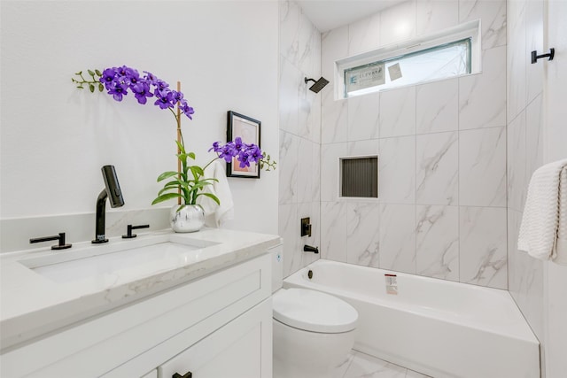 full bathroom with vanity, toilet, and tiled shower / bath