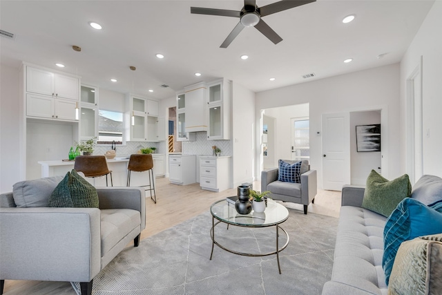 living room featuring ceiling fan and light hardwood / wood-style floors