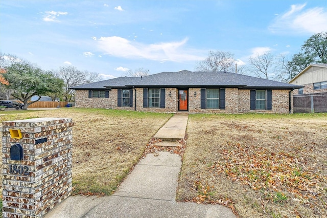 ranch-style home with a front lawn