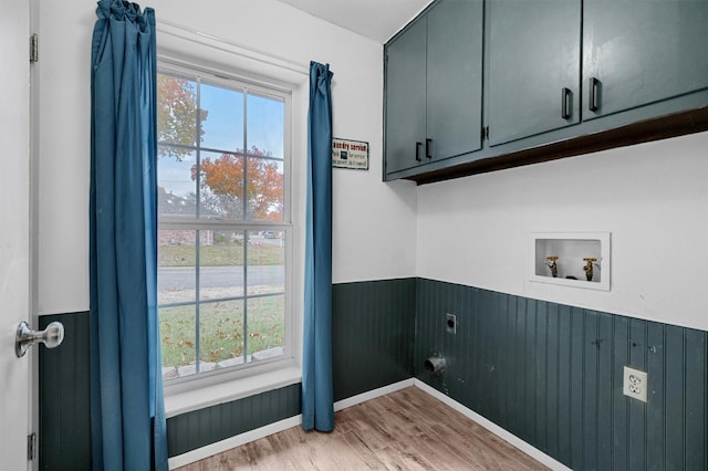 washroom with cabinets, washer hookup, plenty of natural light, and electric dryer hookup