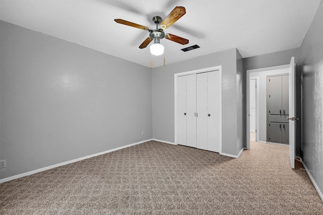 unfurnished bedroom with carpet floors, ceiling fan, and a closet