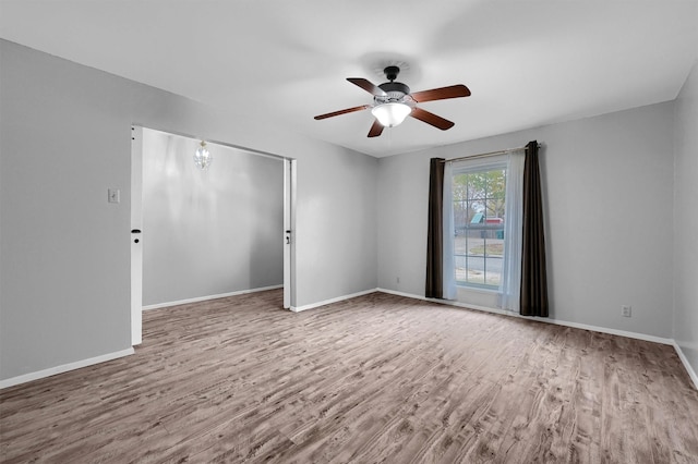 empty room featuring hardwood / wood-style flooring and ceiling fan