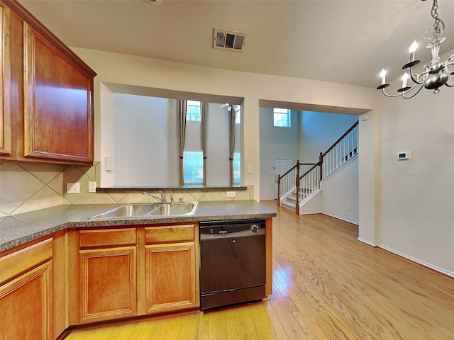 4133 Kyndra Cir, Richardson, TX 75082 - kitchen with a sink, light wood-style floors, black dishwasher, tasteful backsplash, and visible vents